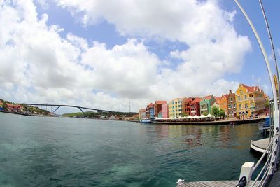 Bridge over sea against sky in city