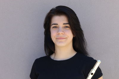 Portrait of smiling young woman against white background