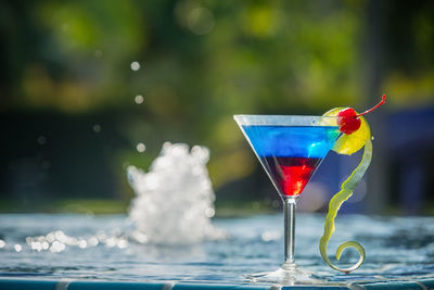 Drink in martini glass by fountain