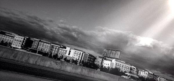 Silhouette of woman against cloudy sky