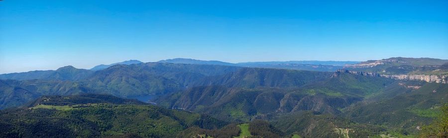 Panoramic view of landscape against clear blue sky