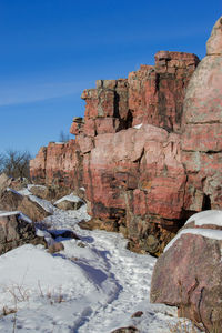 Rock formation against clear sky during winter