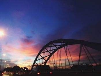 Silhouette bridge against sky during sunset