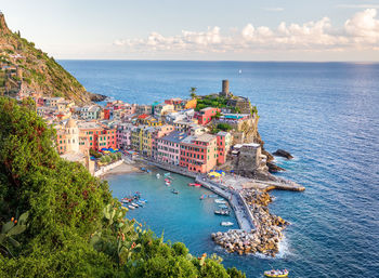 High angle view of townscape by sea against sky