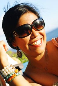 Portrait of a smiling young woman wearing sunglasses