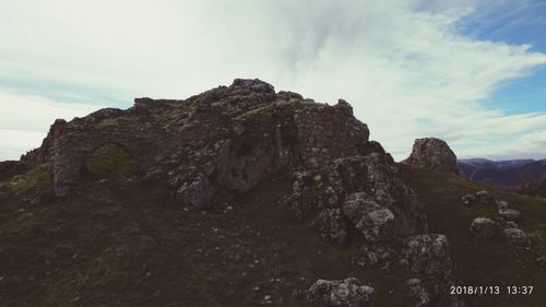 Scenic view of cliff against sky