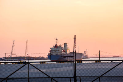 Ship in sea against sky during sunset