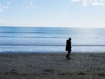 Silhouette of man standing on beach