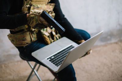 Low angle view of woman working on mobile phone