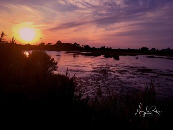 Scenic view of lake against sky during sunset