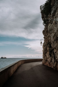 Road by sea against sky