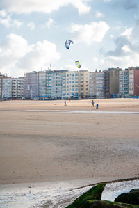 Kitesurfer riding on a sandy beach at the belgium coast at autumn