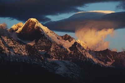 Scenic view of snowcapped mountains against sky during sunset