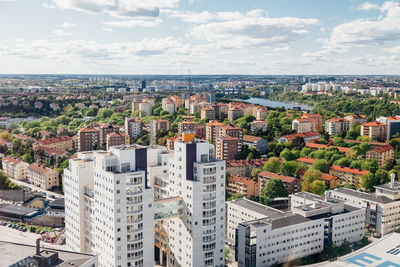 High angle view of cityscape against cloudy sky