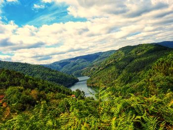 Scenic view of lake and mountains against sky