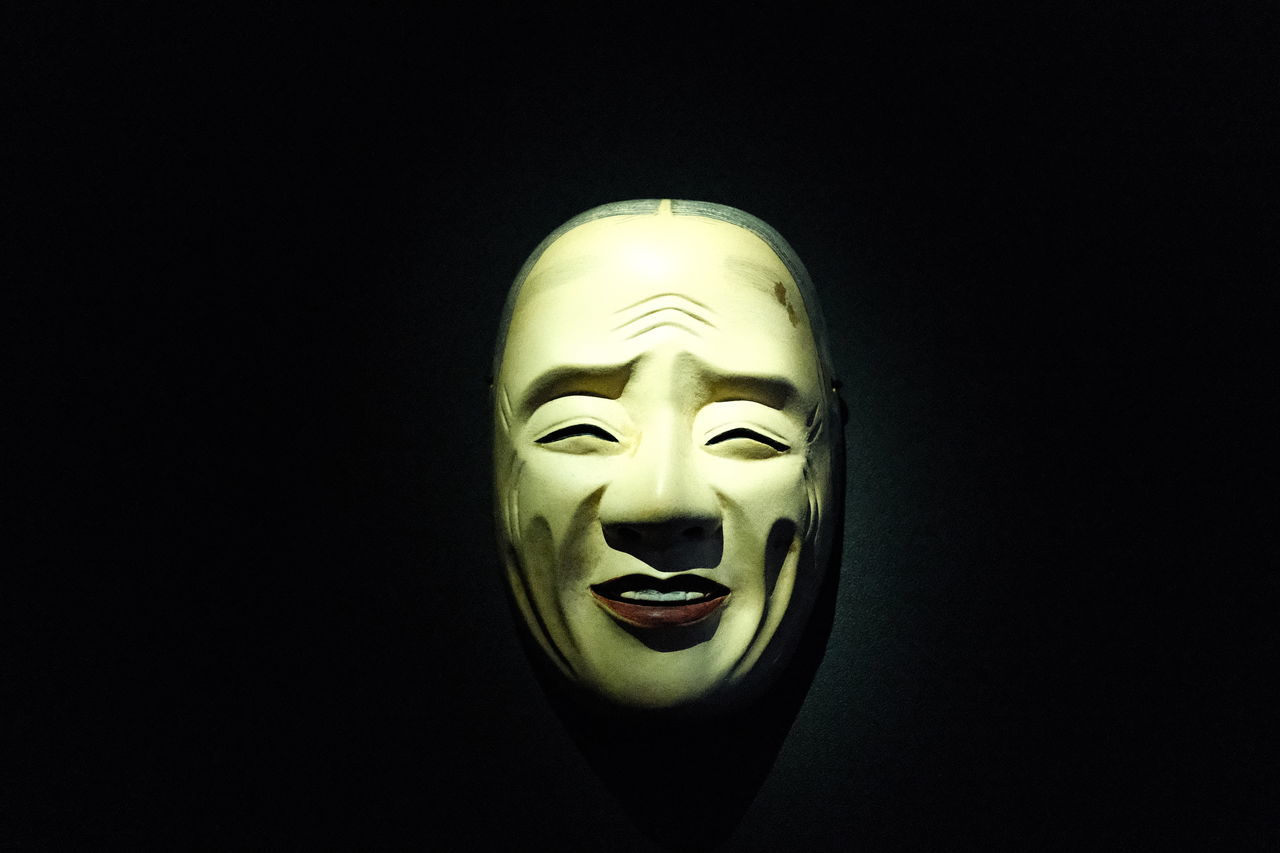 costume, human head, black background, mask, disguise, mask - disguise, masque, clothing, human face, representation, human representation, darkness, indoors, studio shot, copy space, single object, creativity, close-up, craft, sculpture, celebration, mystery