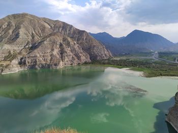 Scenic view of lake and mountains against sky