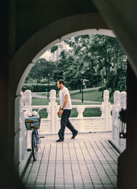 Side view of man standing at archway