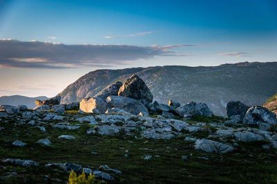 Rock formations on landscape against sky during sunset