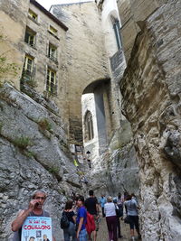 Low angle view of people on historic building