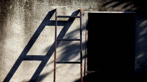 Shadow of railing on wall