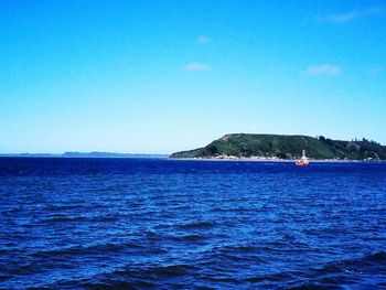 Scenic view of sea against clear blue sky