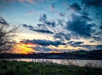 Scenic view of lake against sky during sunset