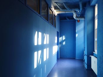 Sunlight on wall in empty corridor