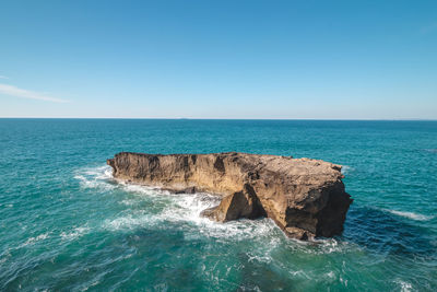 Scenic view of sea against clear blue sky