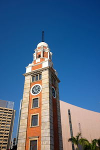 Low angle view of bell tower against blue sky