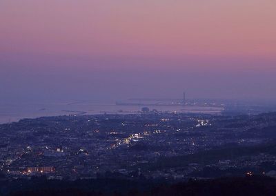 Aerial view of illuminated city at night