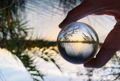 Close-up of hand holding crystal ball