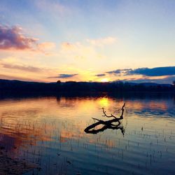 Scenic view of lake against sky during sunset