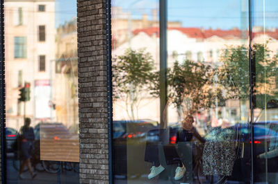 Urban background with large shop windows reflecting the street with people and traffic, closeup