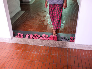 Low section of woman standing on footpath