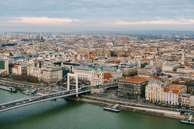 High angle view of river amidst buildings in city against sky