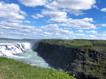 Scenic view of land and sea against sky