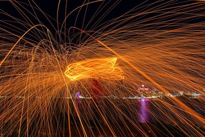 Blurred motion of wire wool by river at night