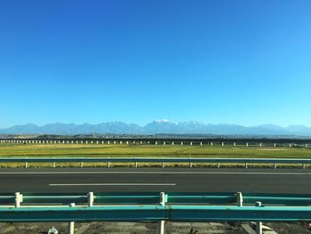 Agricultural field against clear blue sky