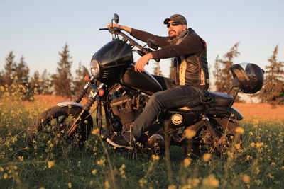 Man riding motorcycle on field