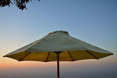 Umbrella against clear blue sky