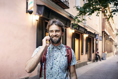 Portrait of woman standing on street in city