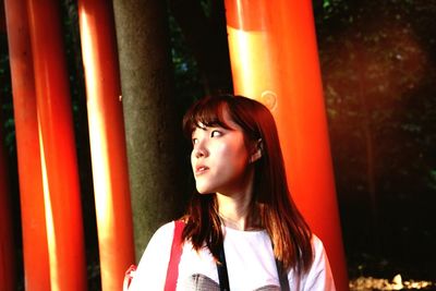 Portrait of beautiful young woman looking away