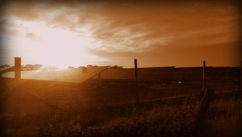 Scenic view of field against sky during sunset