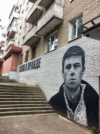 Low angle view of man on staircase against building