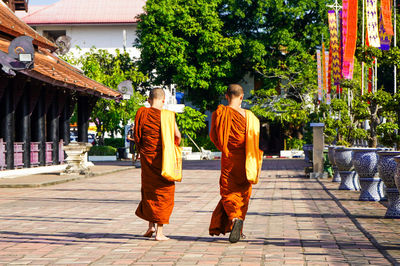 Buddhist monks walking in temple complex in chiang mai thailand