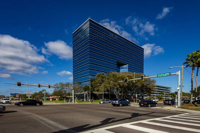 View of city street against blue sky
