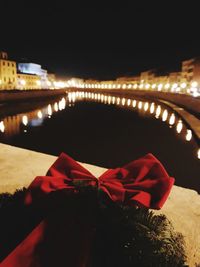 Scenic view of illuminated christmas lights against sky at night