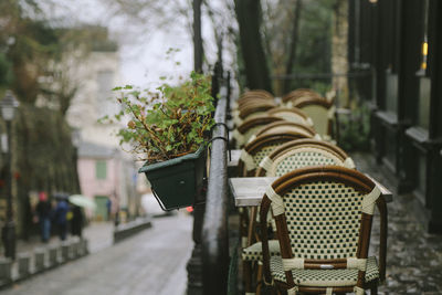 Chairs on table by street