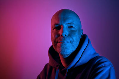 Portrait illuminated of neon lighting. successful and determined middle aged man.